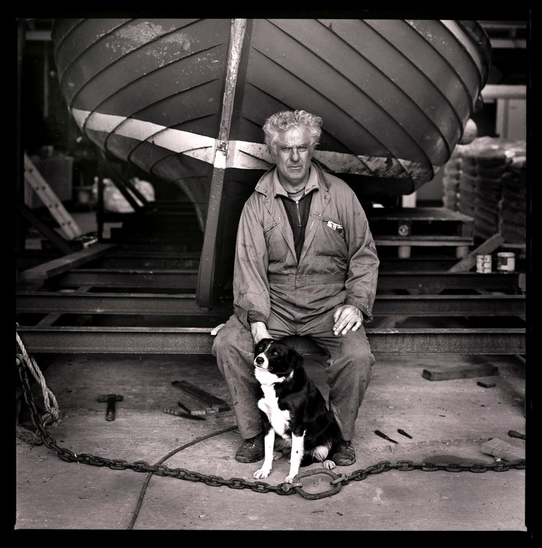 Don Brady with his boat and dog, North Uist