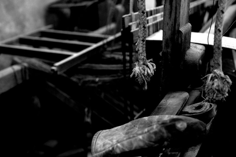 Frayed cords on the old loom
