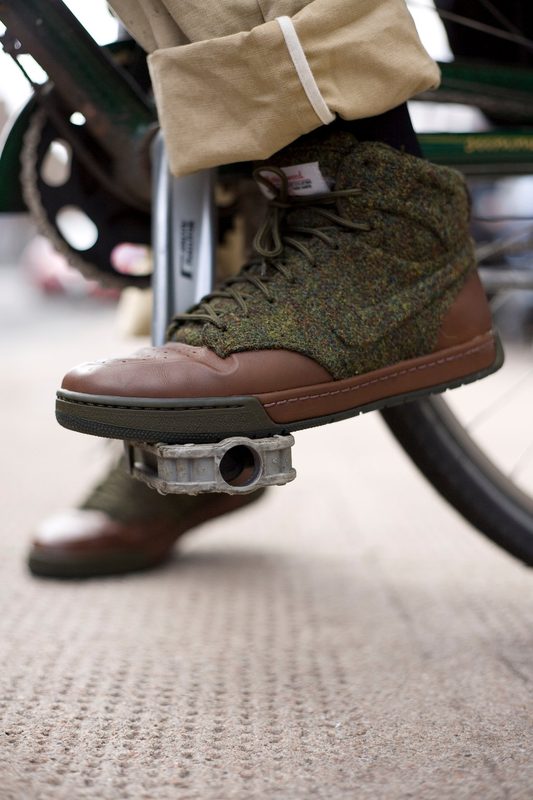 Green tweed Nike trainer at the kerb