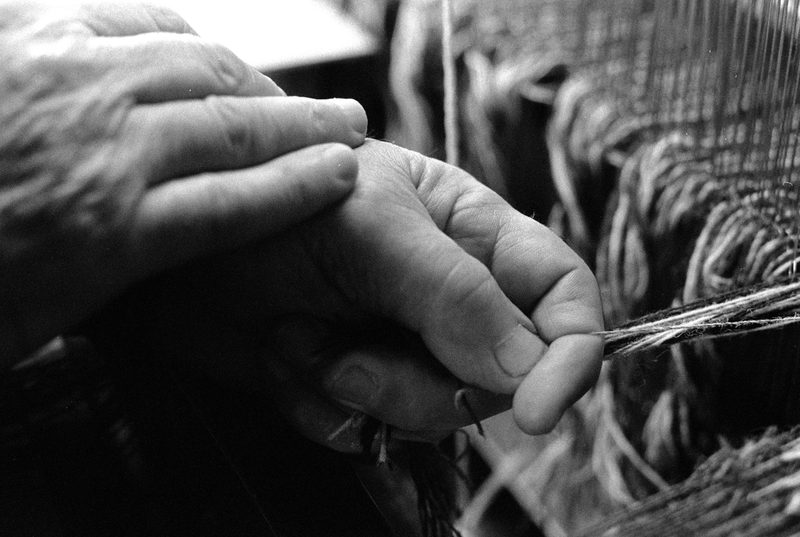 Hands tying on Harris Tweed
