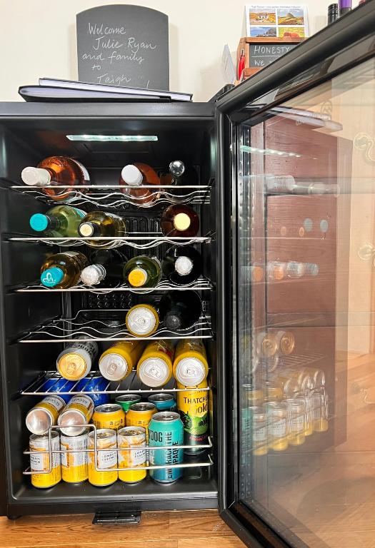 Drinks fridge stocked for the honesty bar